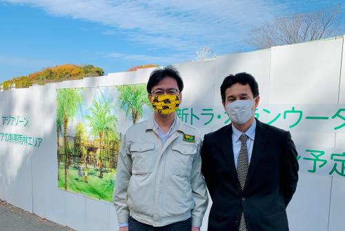 向かって右側が吉住氏・左側が私（後ろは新トラ舎の工事現場です）。.jpg